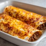 Zwei überbackene Hackfleisch-Wraps mit Käsesauce in einer weißen Auflaufform, bereit zum Servieren.